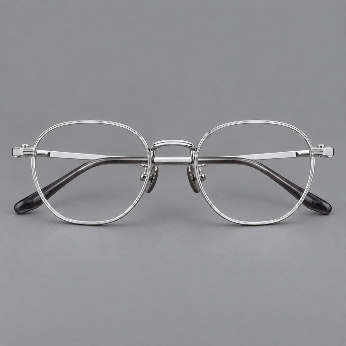 Retro panto titanium glasses with a curved bridge and fine parallel rim grooves in Silver, front view