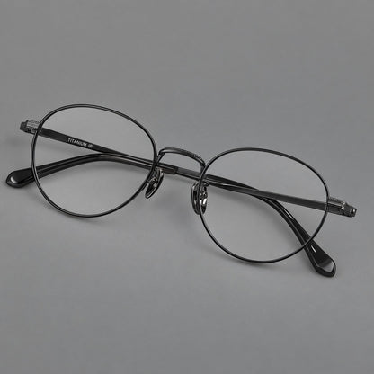 Rounded panto titanium glasses with a raised bridge and dotted temple accents in Black, three quarter view