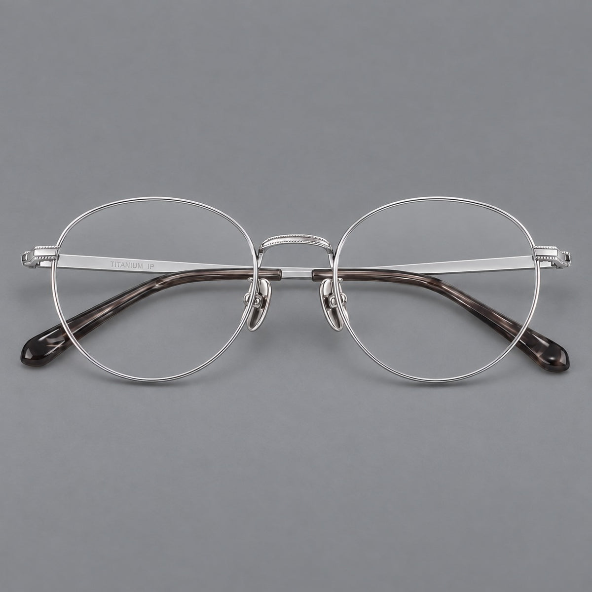 Rounded panto titanium glasses with a raised bridge and dotted temple accents in Silver, front view