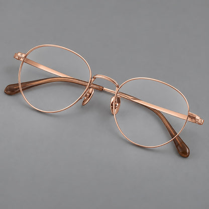 Rounded panto titanium glasses with a raised bridge and dotted temple accents in Rose Gold, three quarter view additional product view