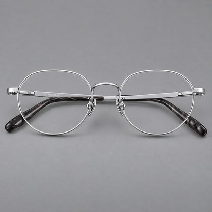 Classic round titanium glasses with broad flat temples and inset hinge details in Silver, front view temple detail