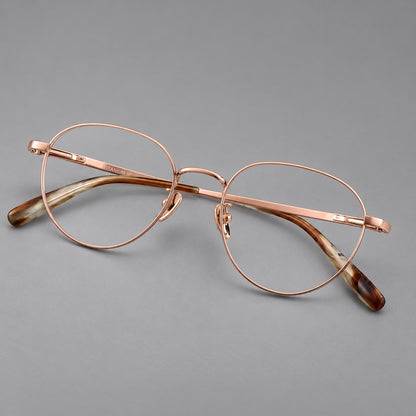 Classic round titanium glasses with broad flat temples and inset hinge details in Rose Gold, three quarter view additional product view