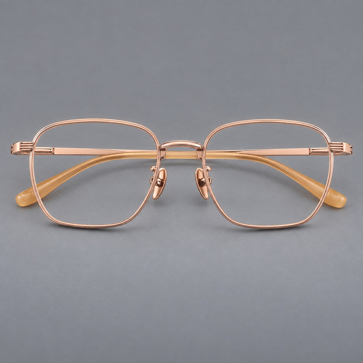 Deep square titanium glasses with a flatter brow and grooved outer shoulders in Rose Gold, front view