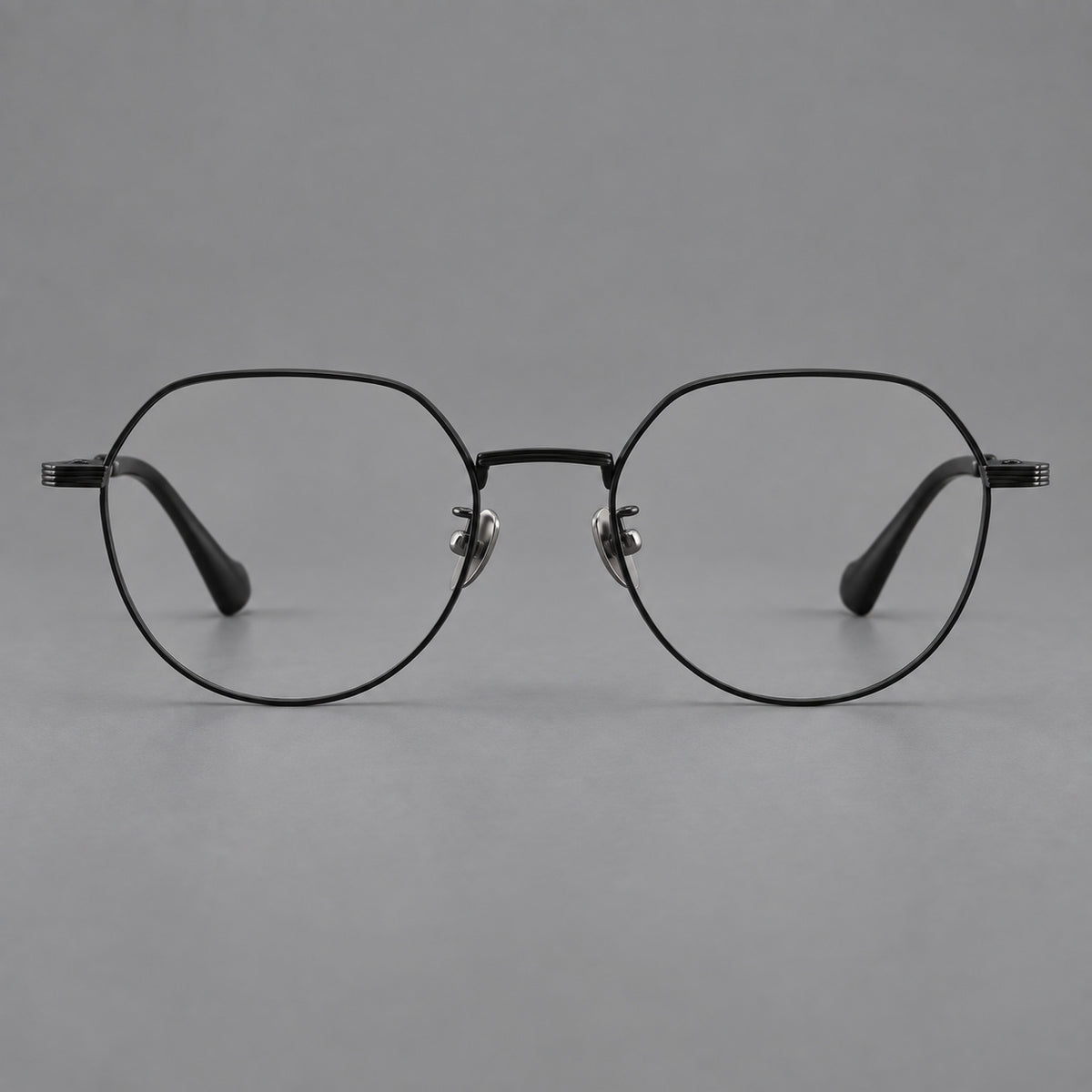 Geometric titanium glasses with soft polygonal rims and fine shoulder detailing in Black, front view