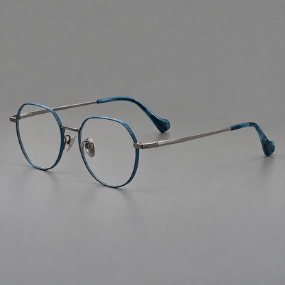 Geometric titanium glasses with soft polygonal rims and fine shoulder detailing in Blue and Gunmetal, three quarter view front view