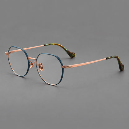 Geometric titanium glasses with soft polygonal rims and fine shoulder detailing in Blue and Rose Gold, three quarter view lens detail
