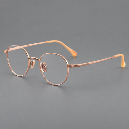 Compact round titanium glasses with an arched bridge and textured temple accents in Rose Gold, three quarter view additional product view