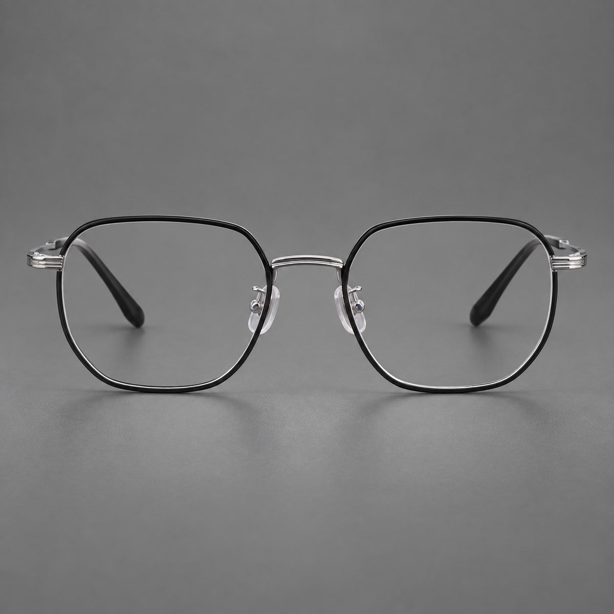 Geometric titanium glasses with flattened corners and a finely ridged bridge in Black and Silver, front view