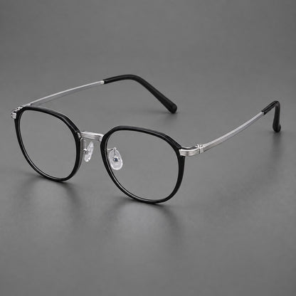 Geometric titanium glasses with flattened corners and a finely ridged bridge in Black and Silver, three quarter view lens detail