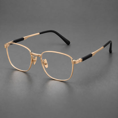 Slim rectangular titanium glasses with broad temples and contrasting dark inserts in Gold, three quarter view lens detail