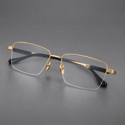 Wide half frame titanium glasses with rectangular lenses and textured temples in Gold, three quarter view lens detail