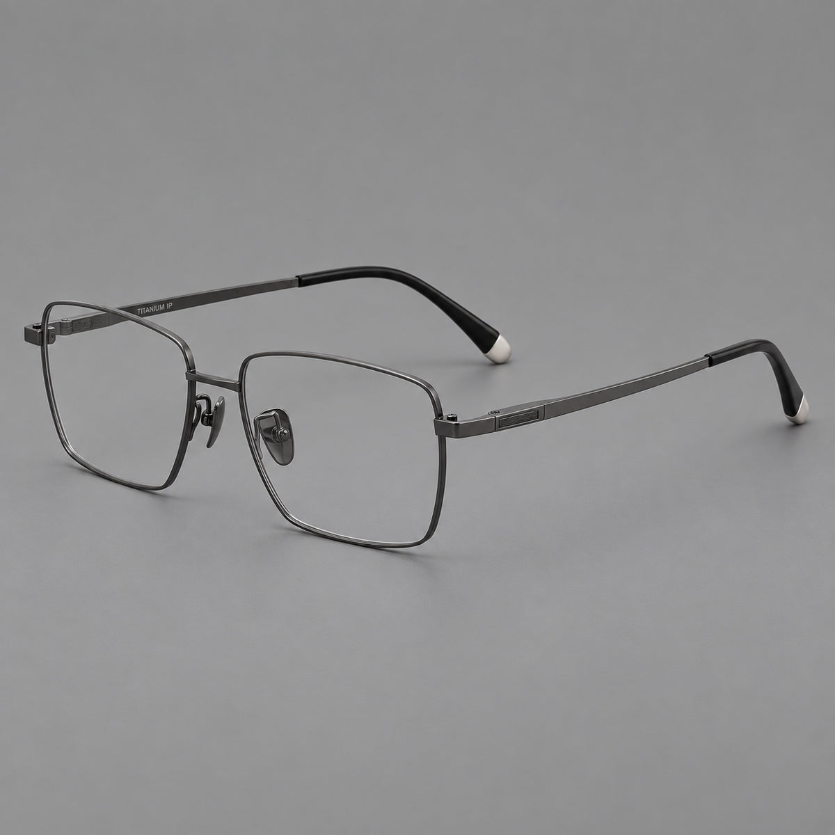Clean rectangular titanium glasses with inset temple details and pale end accents in Gunmetal, three quarter view