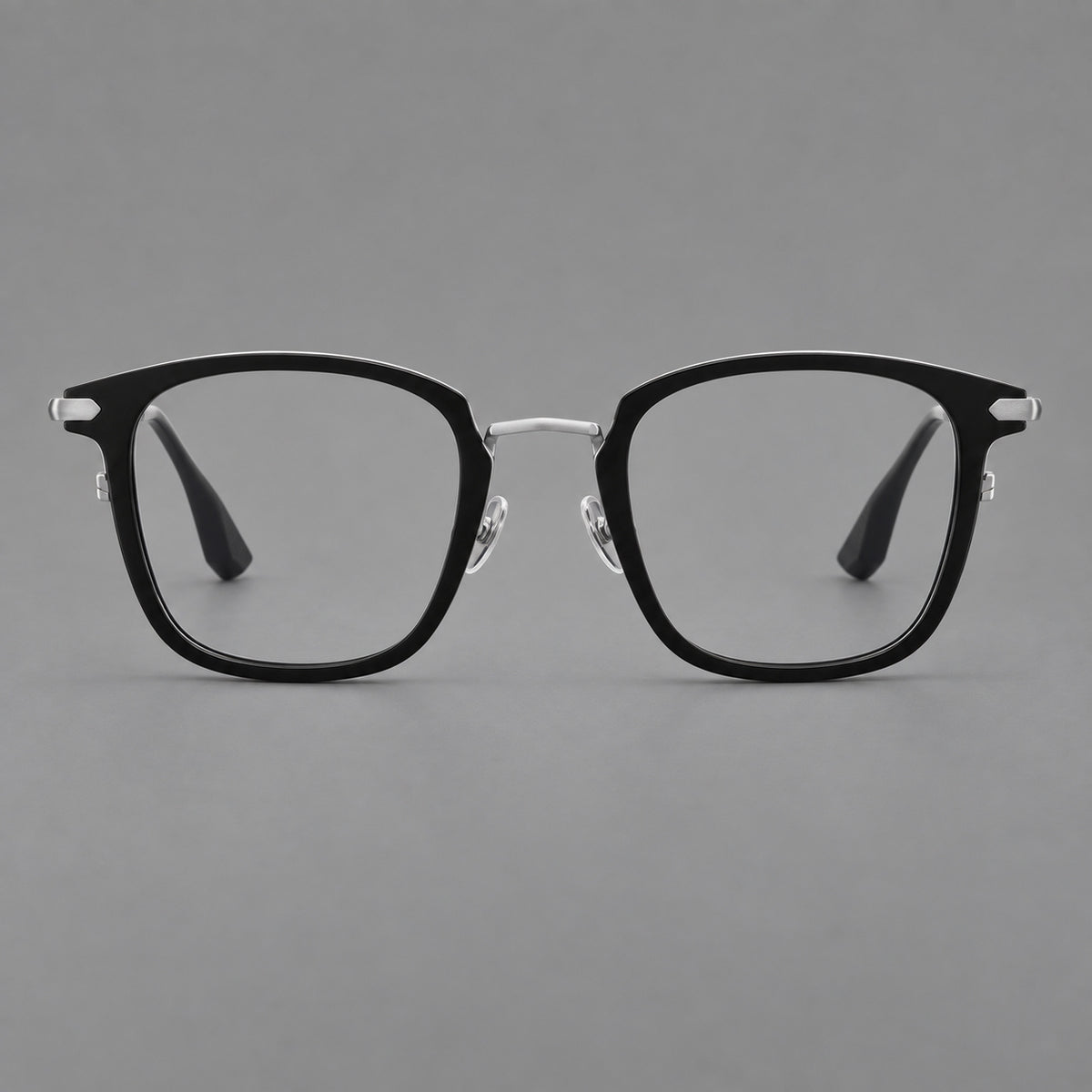 Bold square titanium glasses with a separate bridge and long metal corner accents in Black and Silver, front view