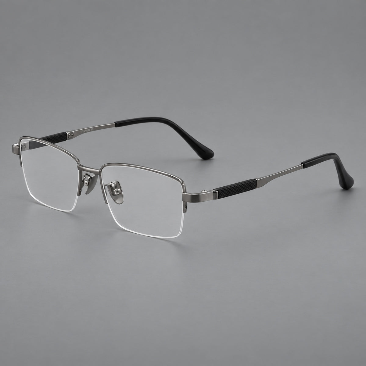 Modern half frame titanium glasses with a narrow bridge and dark temple sections in Grey, three quarter view