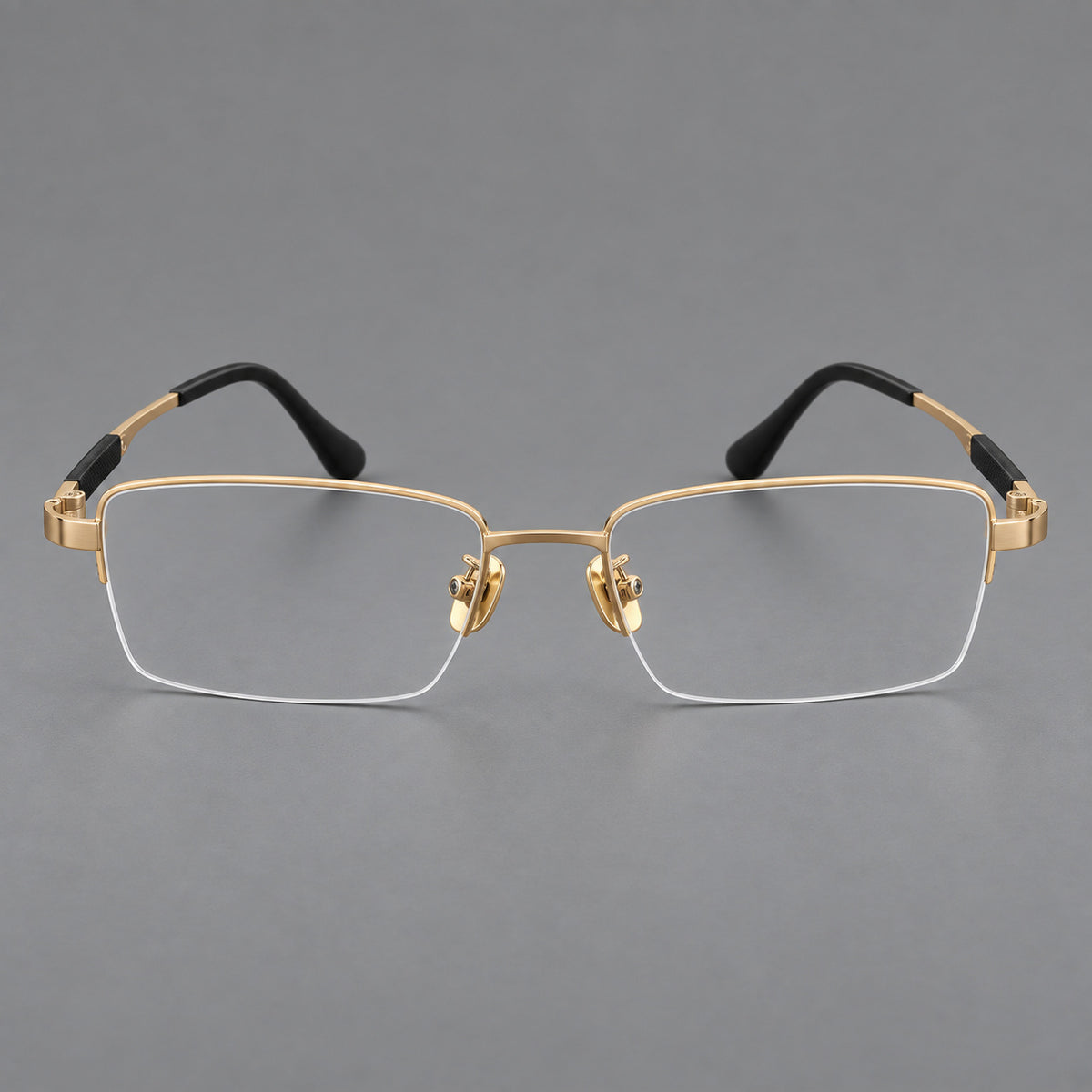 Modern half frame titanium glasses with a narrow bridge and dark temple sections in Gold, front view