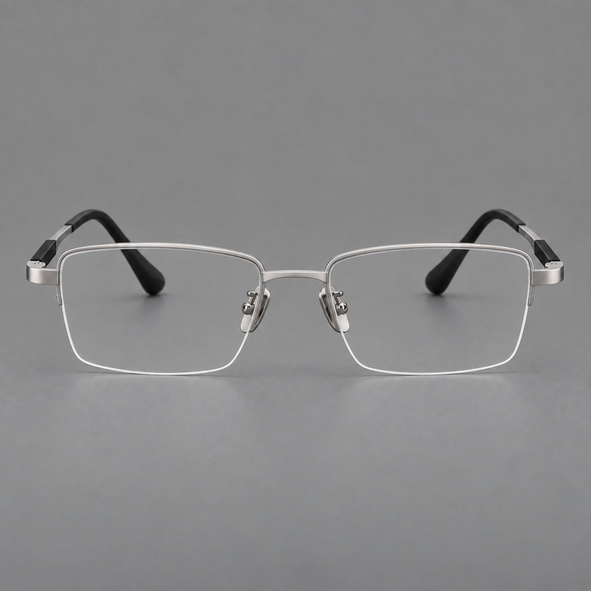 Modern half frame titanium glasses with a narrow bridge and dark temple sections in Silver, front view