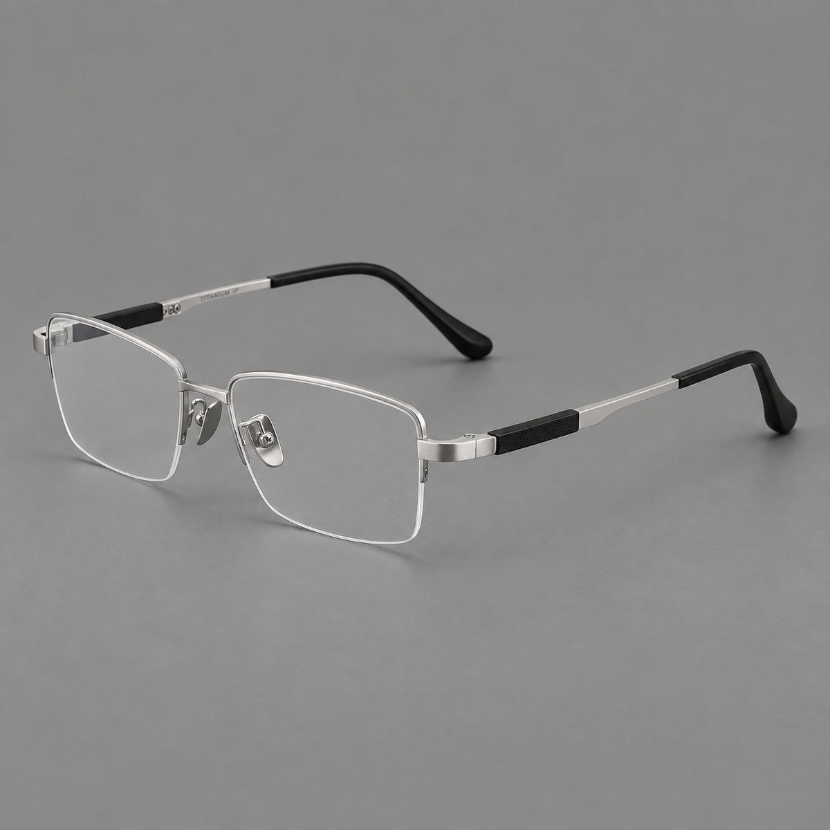 Modern half frame titanium glasses with a narrow bridge and dark temple sections in Silver, three quarter view