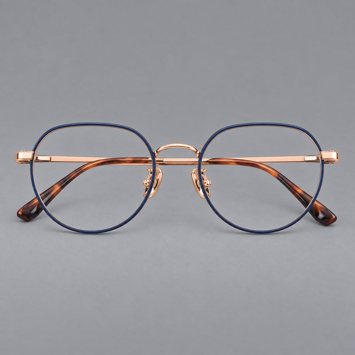 Classic panto titanium glasses with a curved bridge and slim straight temples in Blue and Rose Gold, front view