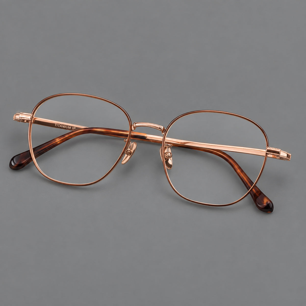 Retro panto titanium glasses with stepped corners and finely engraved temples in Brown and Rose Gold, three quarter view