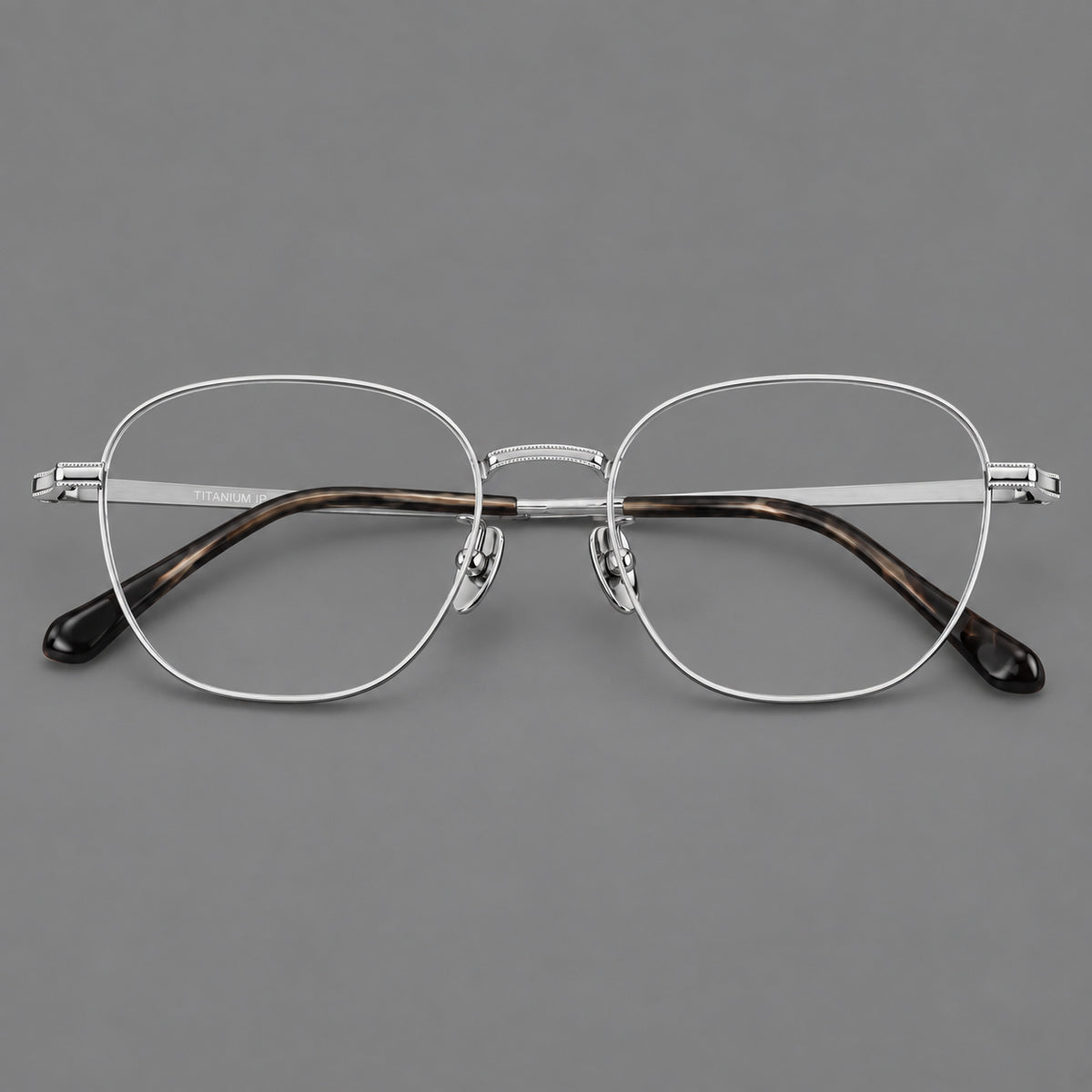 Retro panto titanium glasses with stepped corners and finely engraved temples in Silver, front view