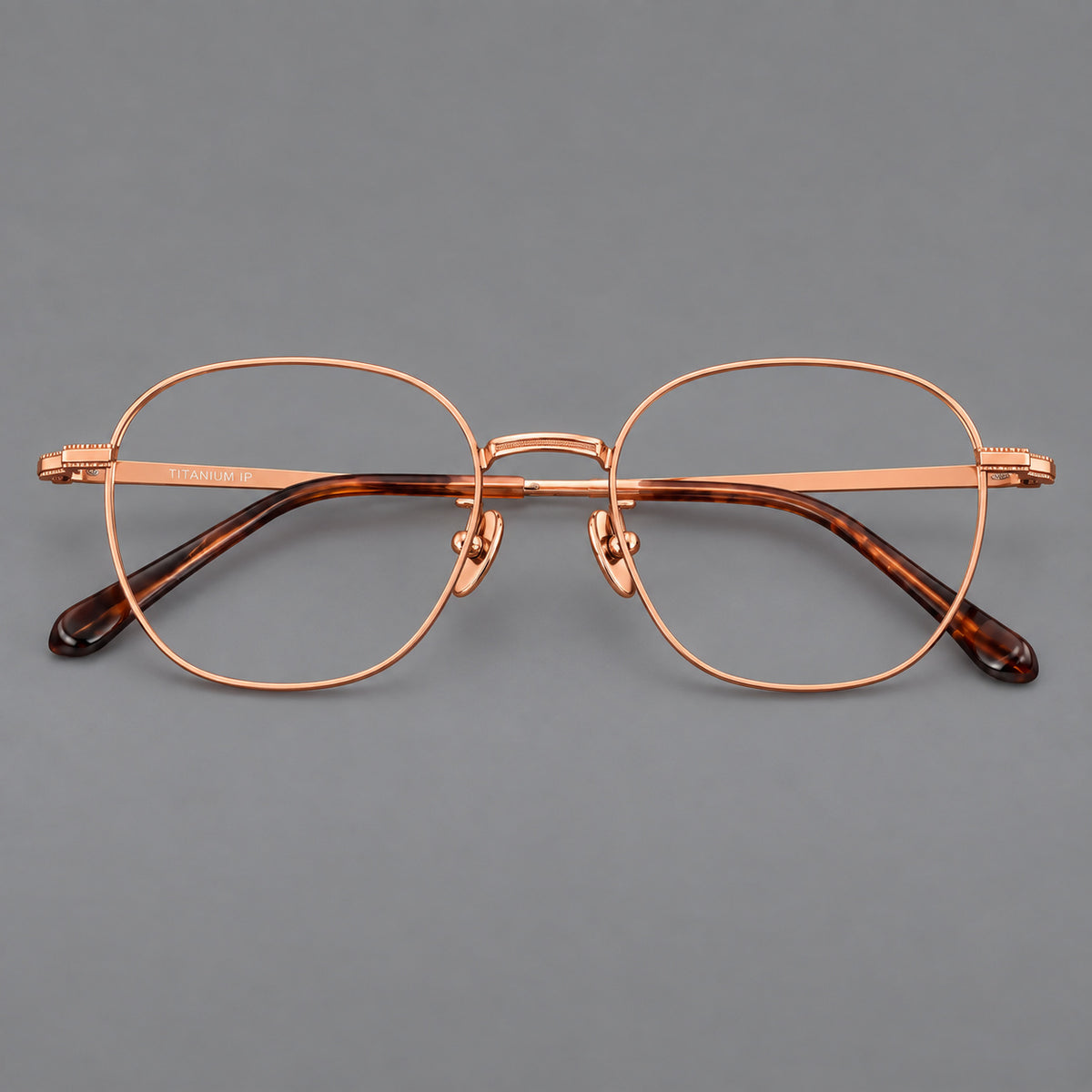 Retro panto titanium glasses with stepped corners and finely engraved temples in Rose Gold, front view
