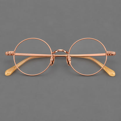 Compact circular titanium glasses with a curved bridge and wavy engraved temples in Rose Gold, front view additional product view