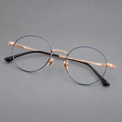 Classic circular titanium glasses with a raised bridge and lined temple accents in Blue and Gold, three quarter view front view