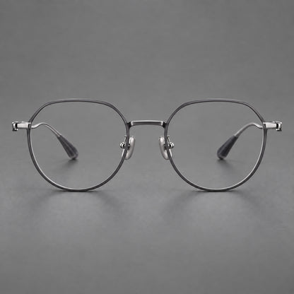 Rounded titanium glasses with a short bridge and distinctive wavy metal temples in Matte Grey and Silver, front view frame detail