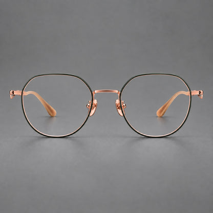 Rounded titanium glasses with a short bridge and distinctive wavy metal temples in Dark Green and Rose Gold, front view temple detail