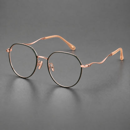Rounded titanium glasses with a short bridge and distinctive wavy metal temples in Dark Green and Rose Gold, three quarter view lens detail