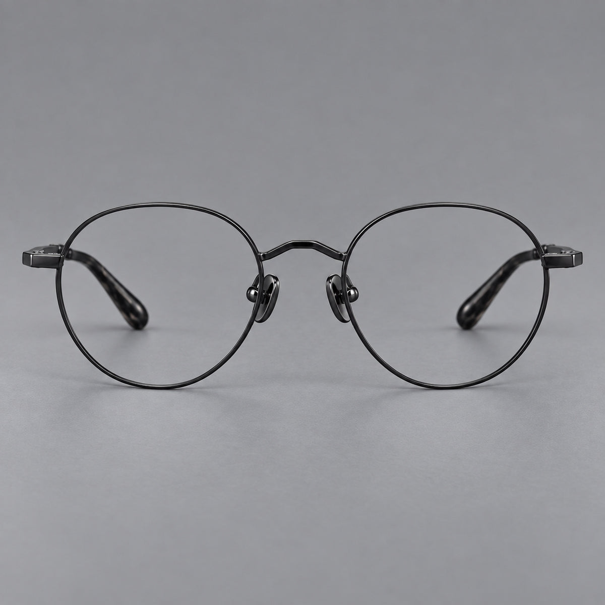 Retro panto titanium glasses with faceted corners and mottled curved temple tips in Black, front view