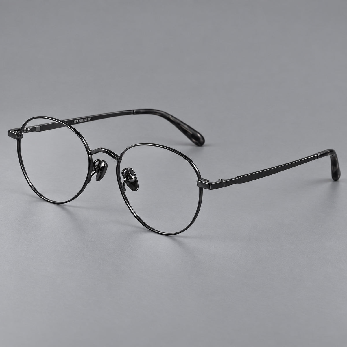 Retro panto titanium glasses with faceted corners and mottled curved temple tips in Black, three quarter view