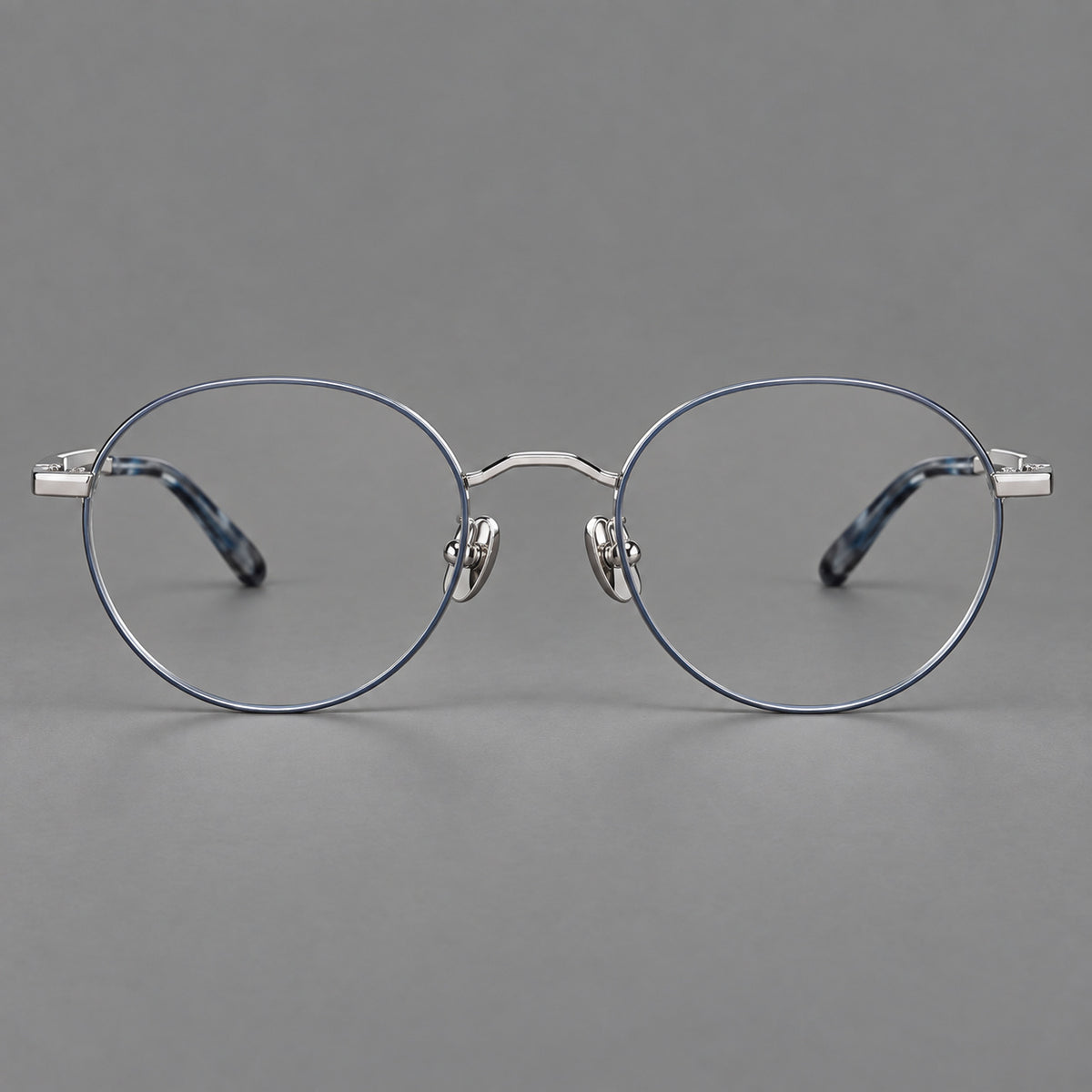 Retro panto titanium glasses with faceted corners and mottled curved temple tips in Grey Blue and Silver, front view