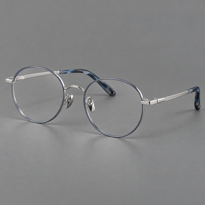 Retro panto titanium glasses with faceted corners and mottled curved temple tips in Grey Blue and Silver, three quarter view lens detail
