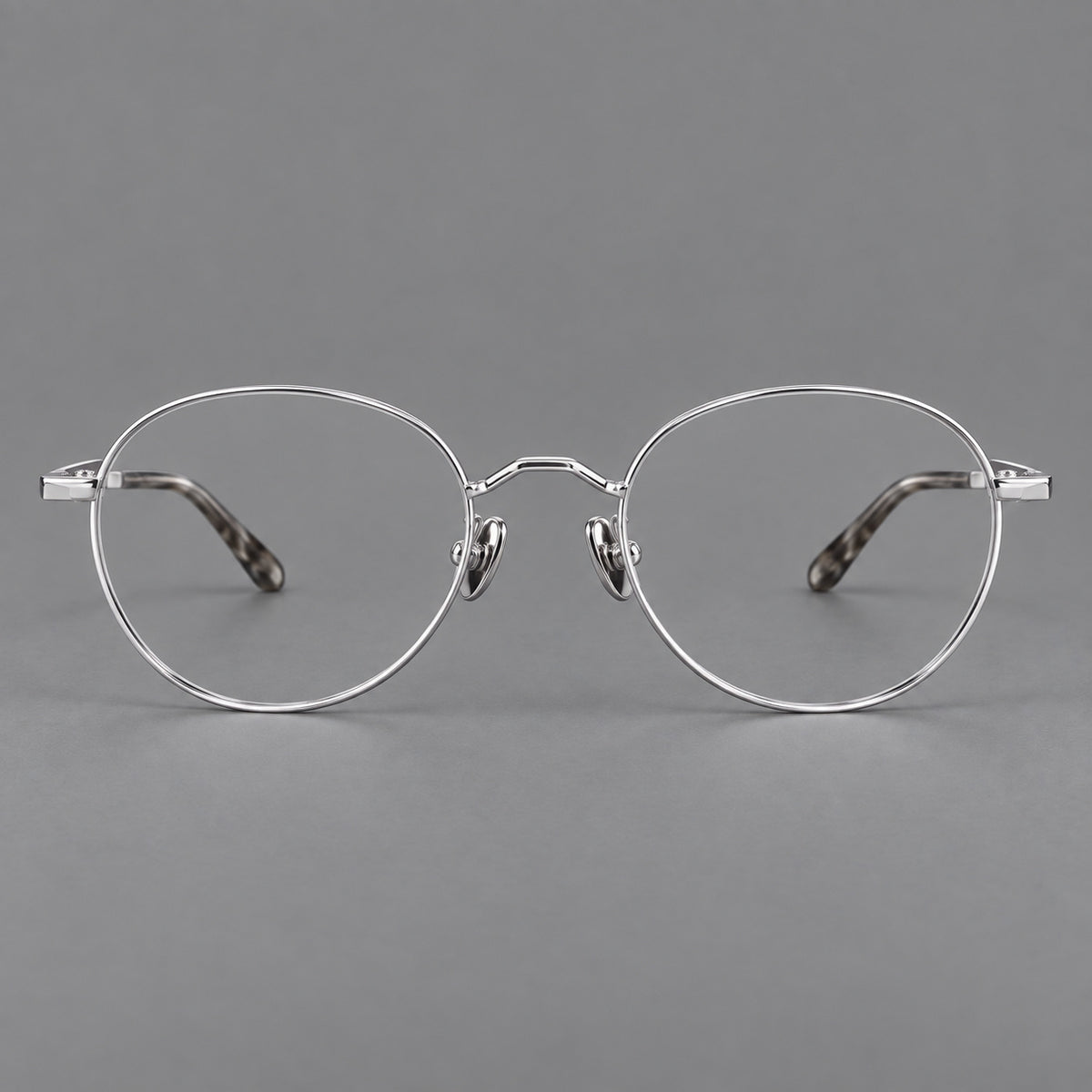Retro panto titanium glasses with faceted corners and mottled curved temple tips in Silver, front view