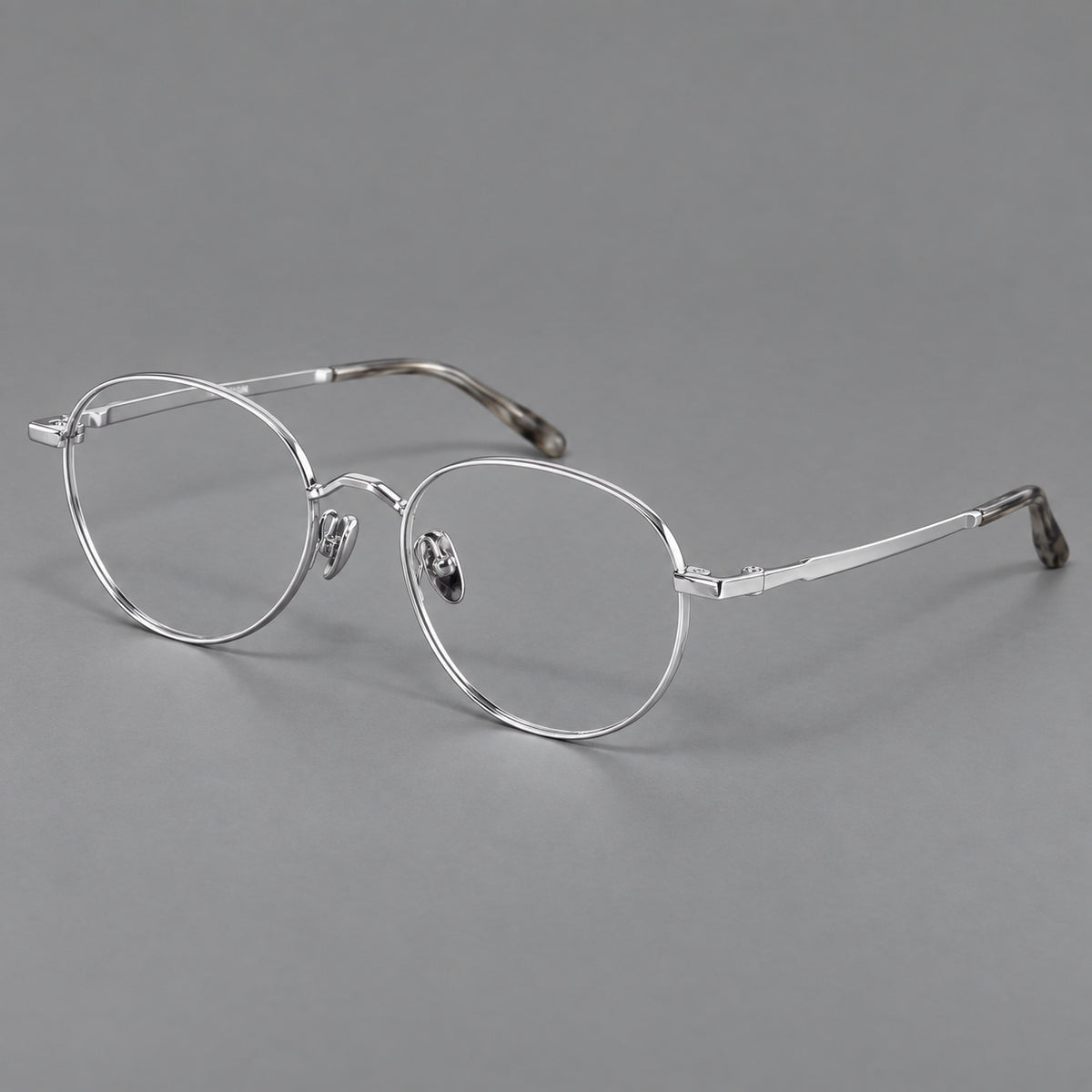 Retro panto titanium glasses with faceted corners and mottled curved temple tips in Silver, three quarter view