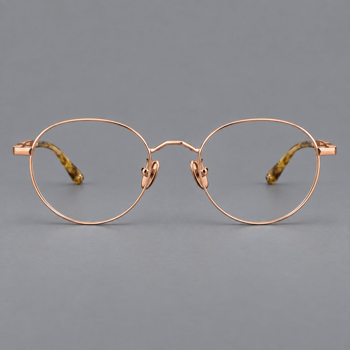 Retro panto titanium glasses with faceted corners and mottled curved temple tips in Rose Gold, front view