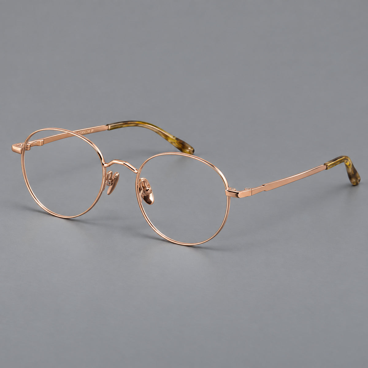 Retro panto titanium glasses with faceted corners and mottled curved temple tips in Rose Gold, three quarter view