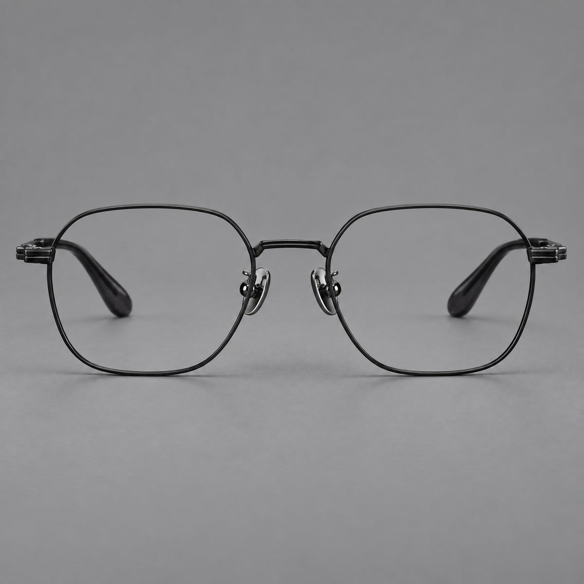 Soft square titanium glasses with an angular bridge and layered corner details in Black, front view