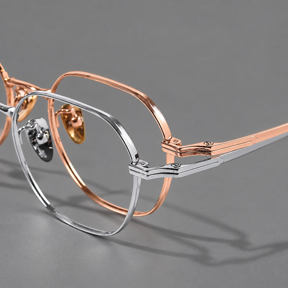 Soft square titanium glasses with an angular bridge and layered corner details, frame details