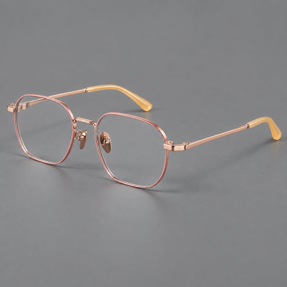 Rounded panto titanium glasses with an angular bridge and broad flat temples in Pink and Rose Gold, three quarter view