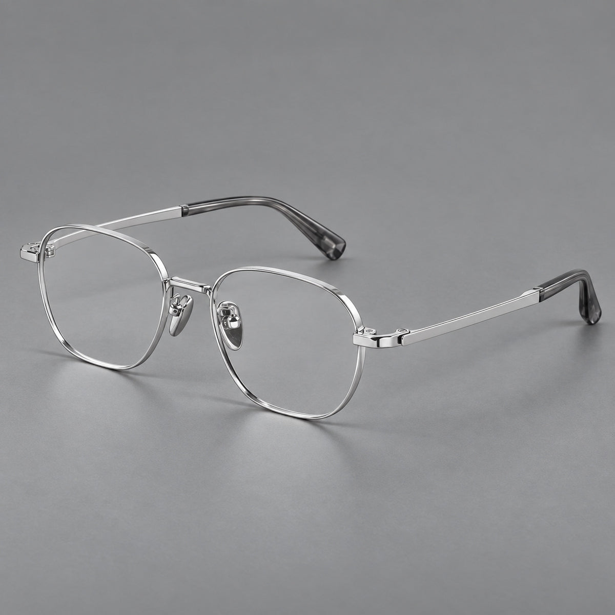 Rounded panto titanium glasses with an angular bridge and broad flat temples in Silver, three quarter view