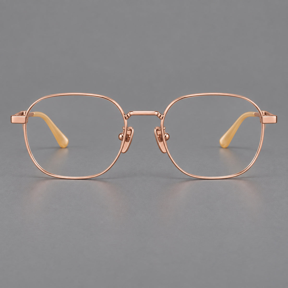 Rounded panto titanium glasses with an angular bridge and broad flat temples in Rose Gold, front view