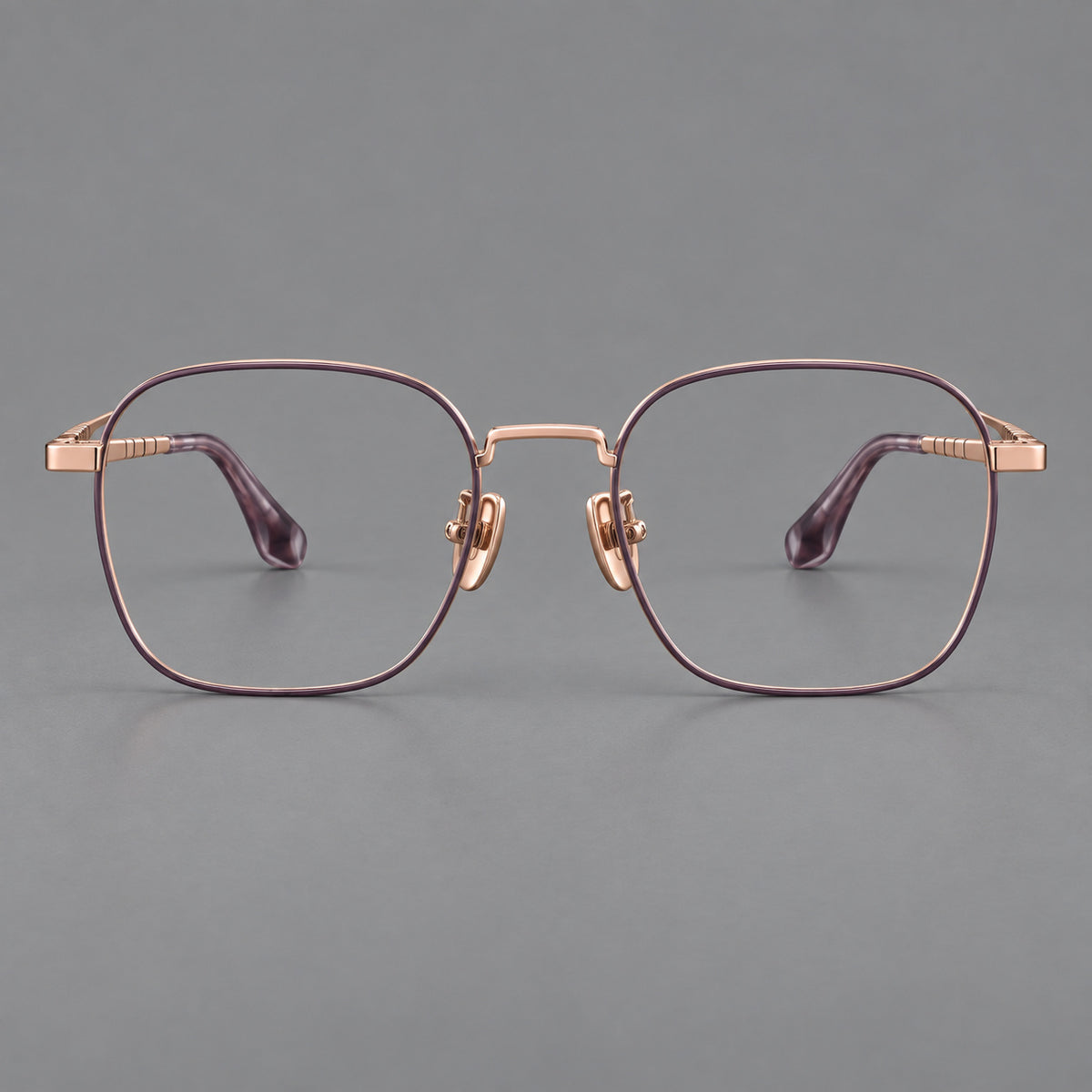 Soft square titanium glasses with a raised bridge and engraved temple bands in Purple and Rose Gold, front view
