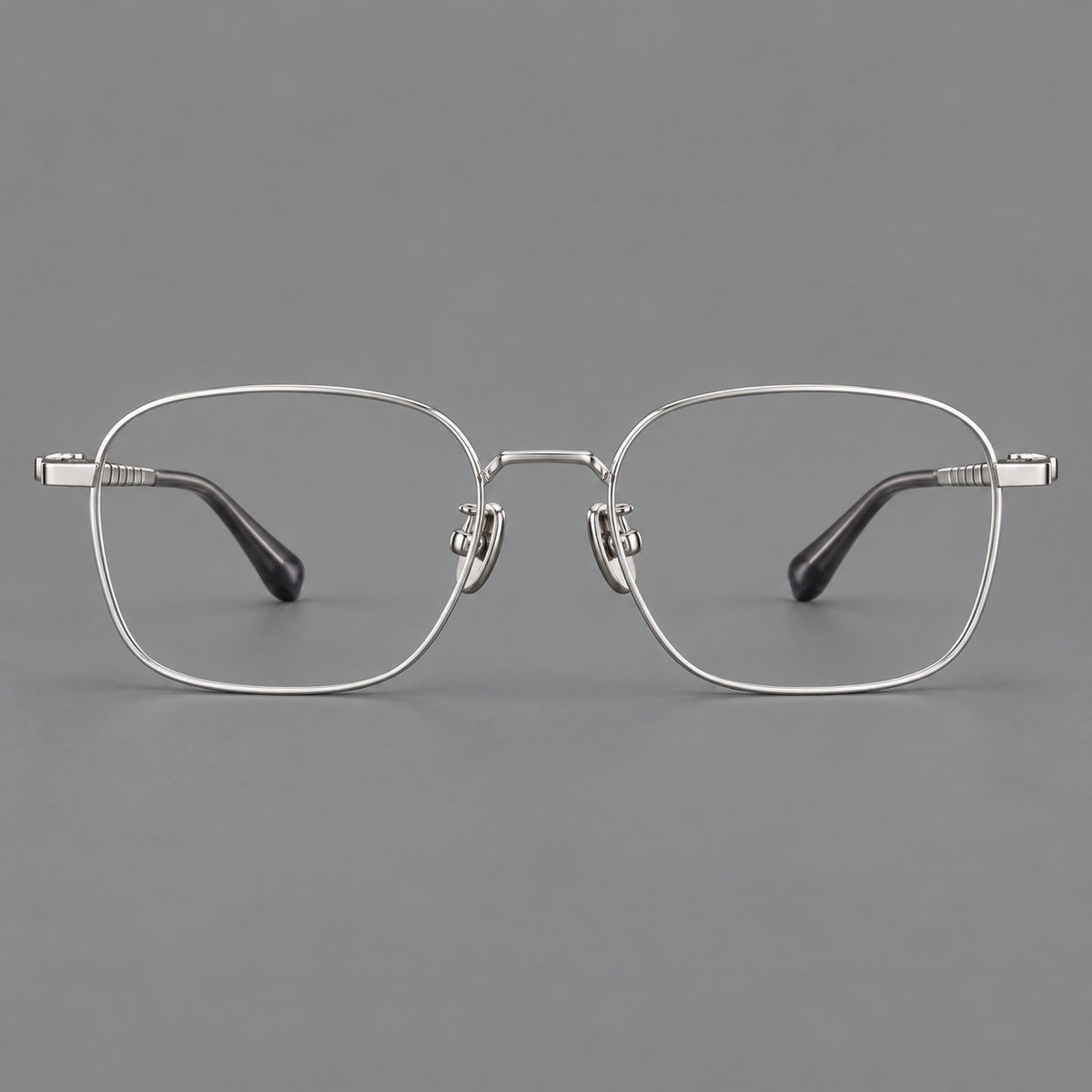 Soft square titanium glasses with a raised bridge and engraved temple bands in Silver, front view