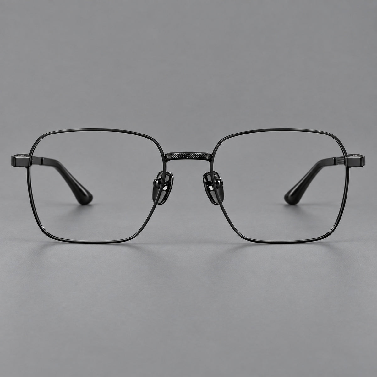 Geometric square titanium glasses with a textured bridge and fine temple grooves in Black, front view