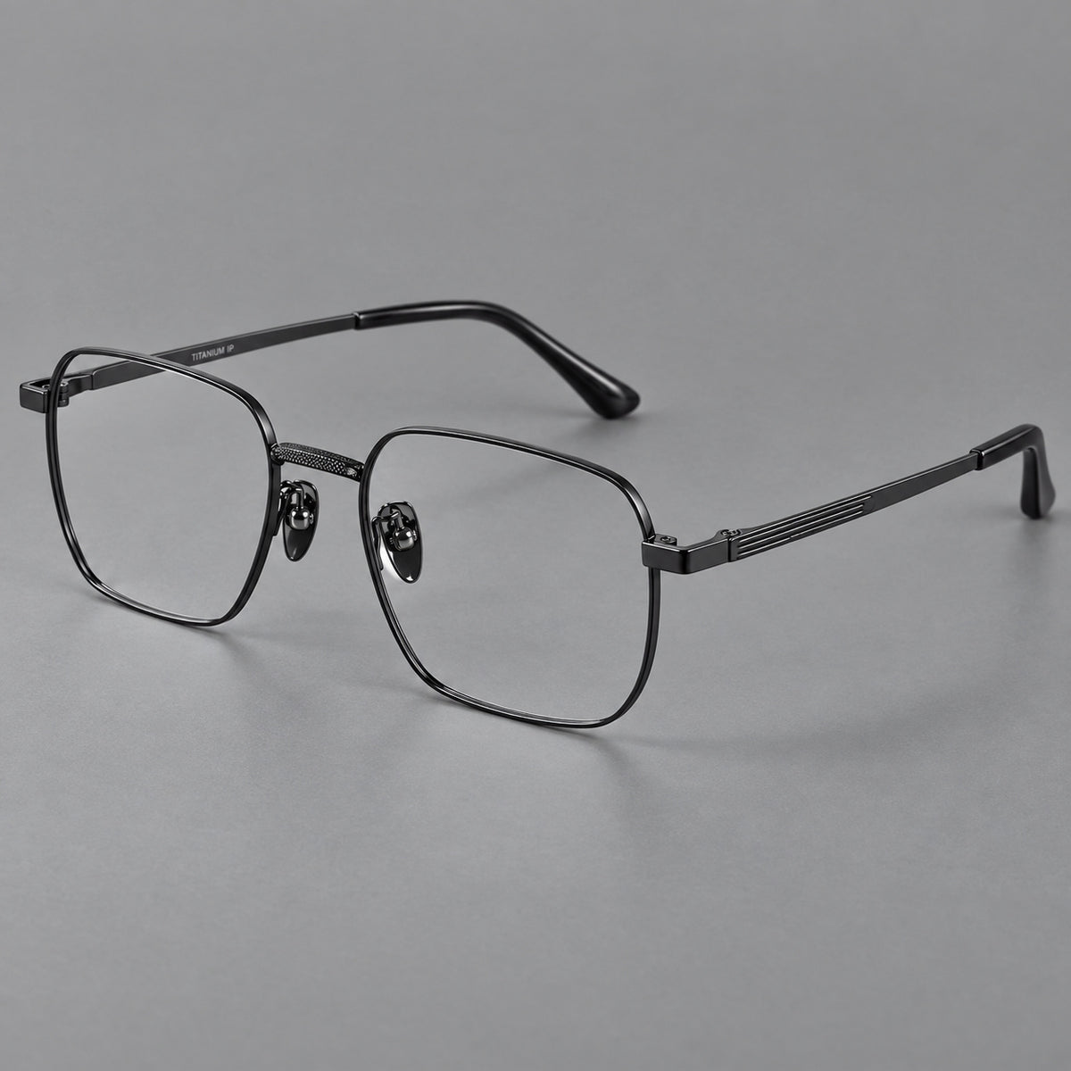Geometric square titanium glasses with a textured bridge and fine temple grooves in Black, three quarter view