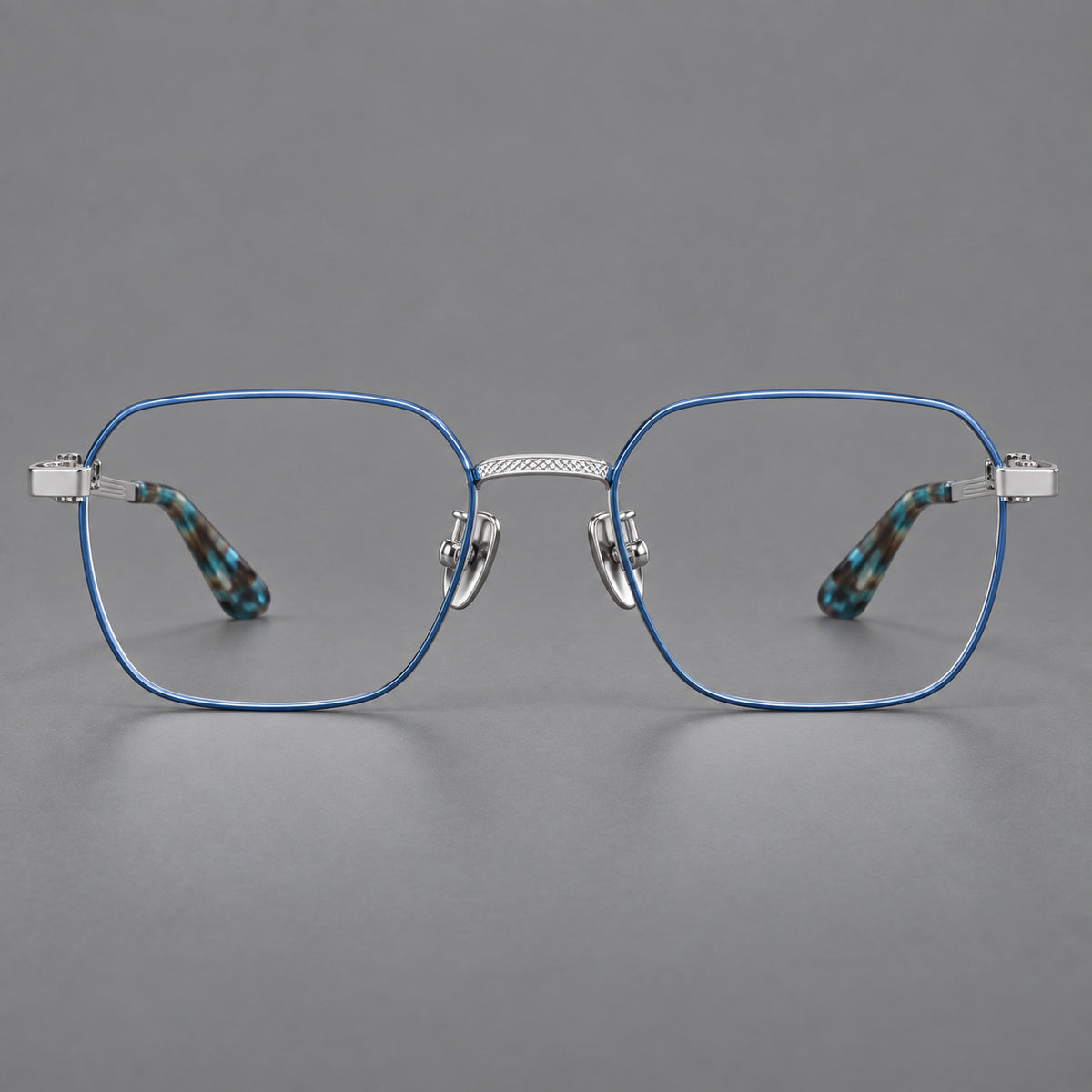 Geometric square titanium glasses with a textured bridge and fine temple grooves in Blue and Silver, front view