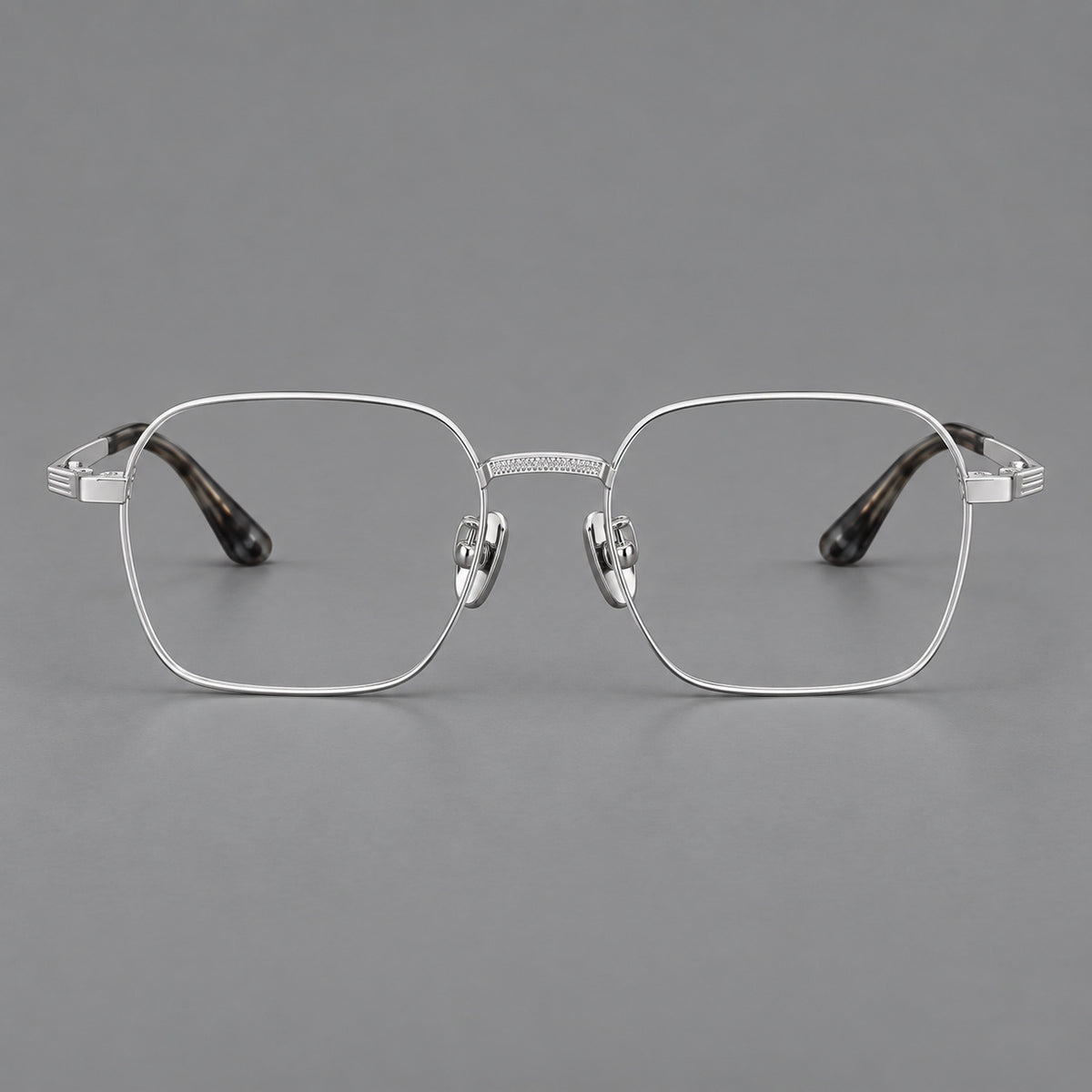 Geometric square titanium glasses with a textured bridge and fine temple grooves in Silver, front view