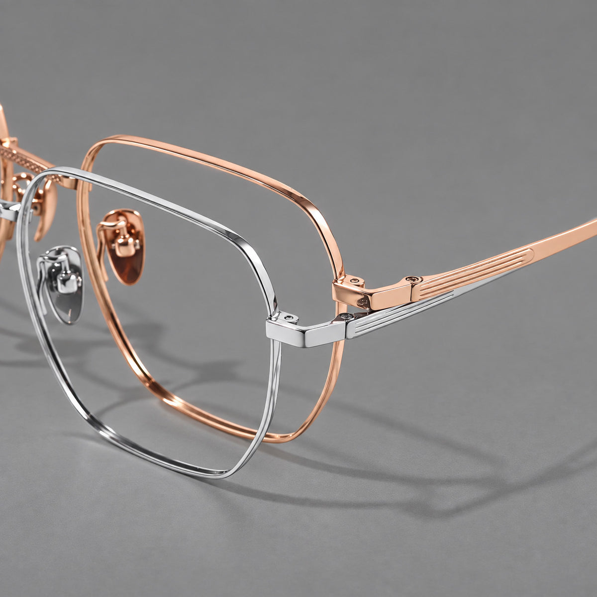 Geometric square titanium glasses with a textured bridge and fine temple grooves, frame details